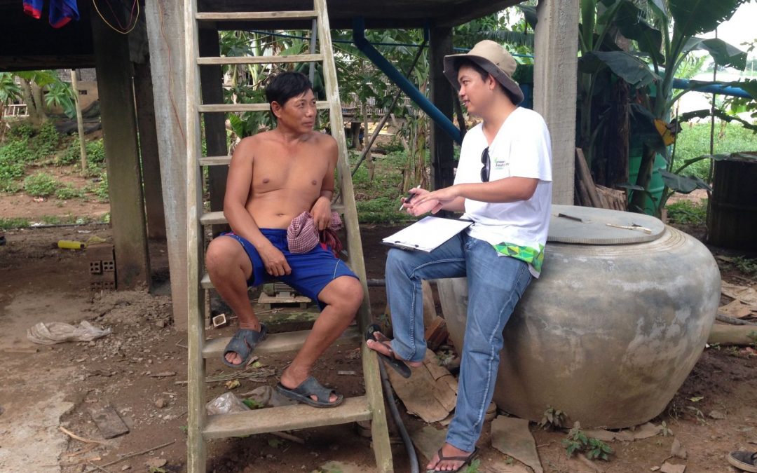 Piseth chats with a local mason about trialling his ATEC* Biodigester system